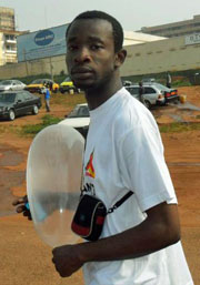 Dominique Menoga con preservativo inflado  en la marcha del Día Mundial de  la lucha contra el SIDA en 2011.